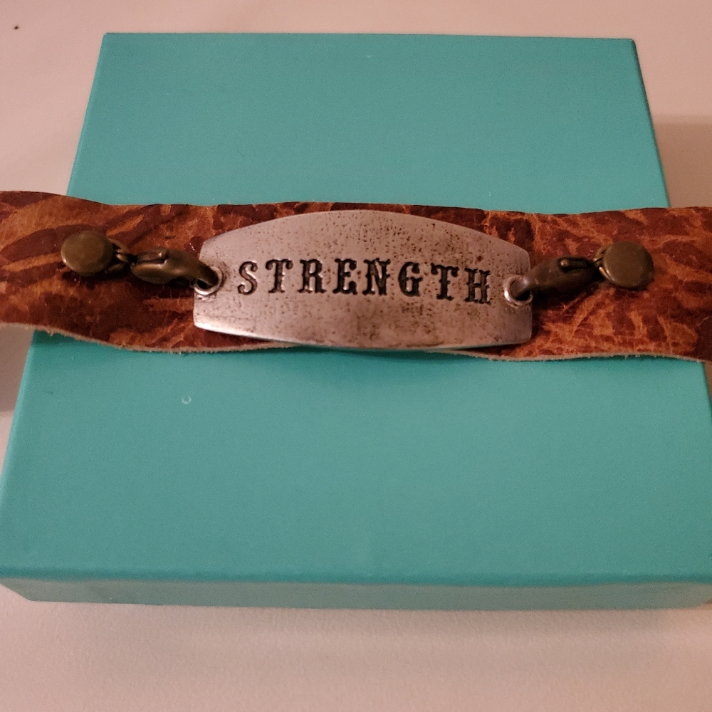 LEATHER TOOLED "STRENGTH " ADJUSTABLE BRACELET.
